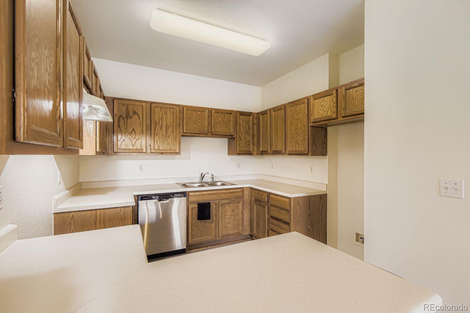 3261 South Waco Court, Unit B Aurora, CO 80013 - Photo 6 of 21 a kitchen with stainless steel appliances granite countertop a sink and a stove