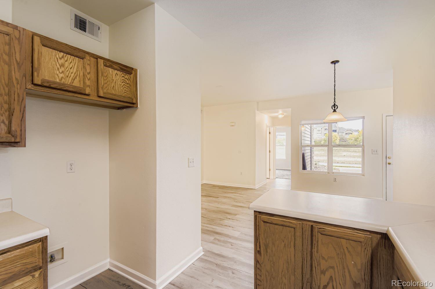 3261 South Waco Court, Unit B Aurora, CO 80013 - Photo 7 of 21 a view of a kitchen cabinets and a wooden floor