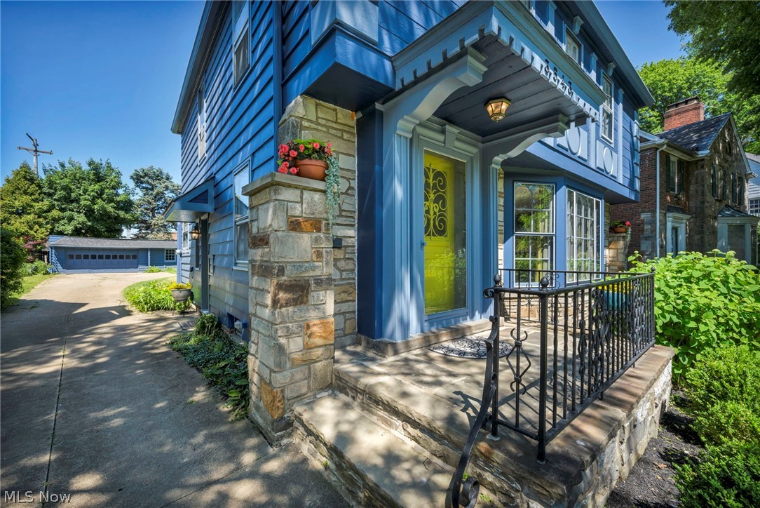 3543 Lytle Road Shaker Heights, OH 44122 - Photo 5 of 49 Blue-sided exterior featuring a stone-clad porch and column