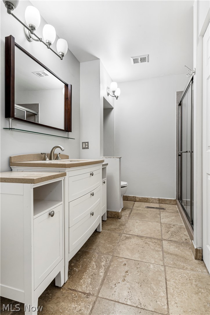 3428 South Smith Road Fairlawn, OH 44333 - Photo 16 of 30 Bathroom featuring a shower with shower door, tile flooring, vanity, and toilet