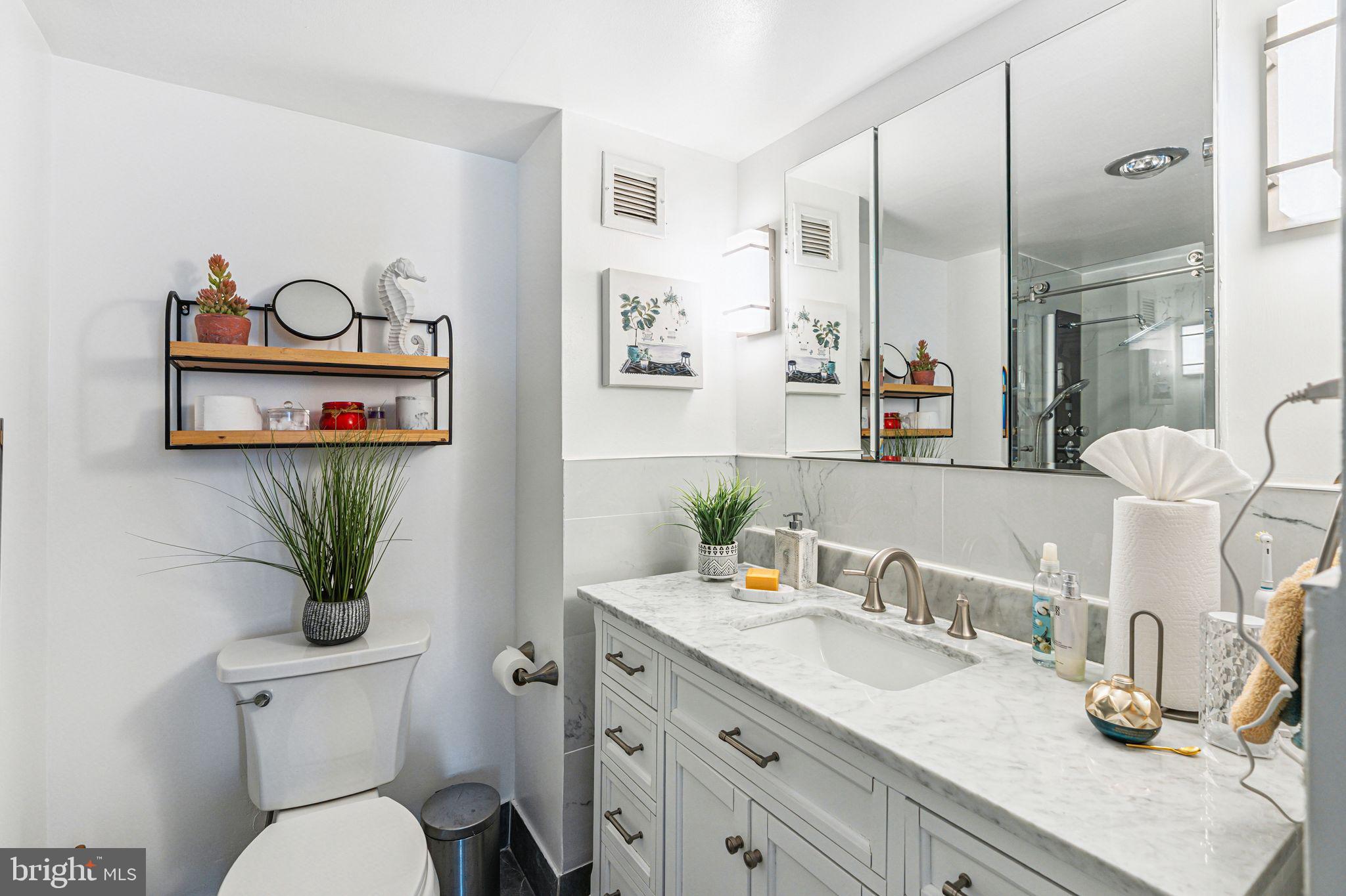 3600 Conshohocken Avenue, Unit 1712 Philadelphia, PA 19131 - Photo 15 of 27 a bathroom with a granite countertop sink mirror and toilet