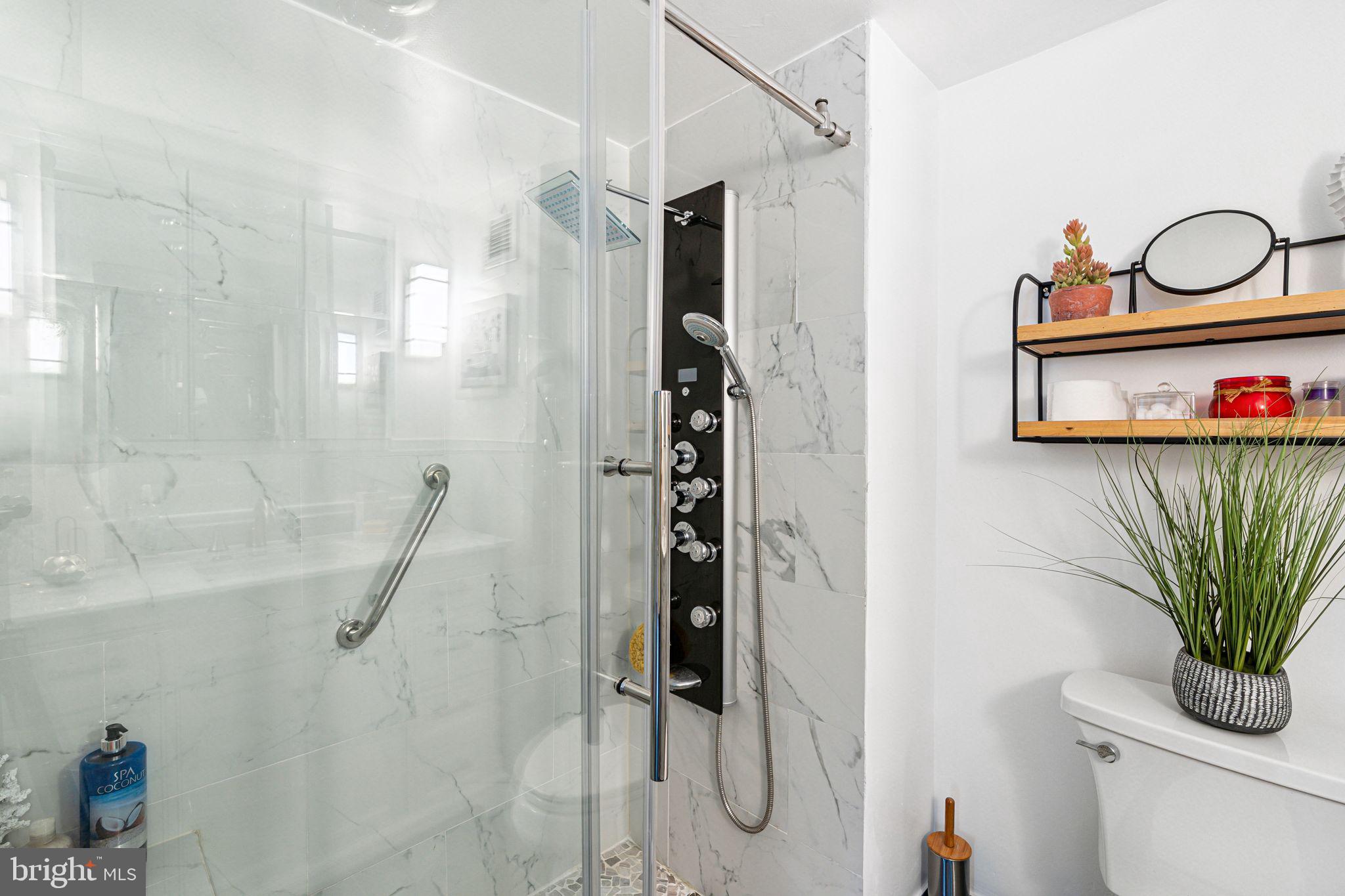 3600 Conshohocken Avenue, Unit 1712 Philadelphia, PA 19131 - Photo 16 of 27 a bathroom with a shower curtain a mirror and a sink