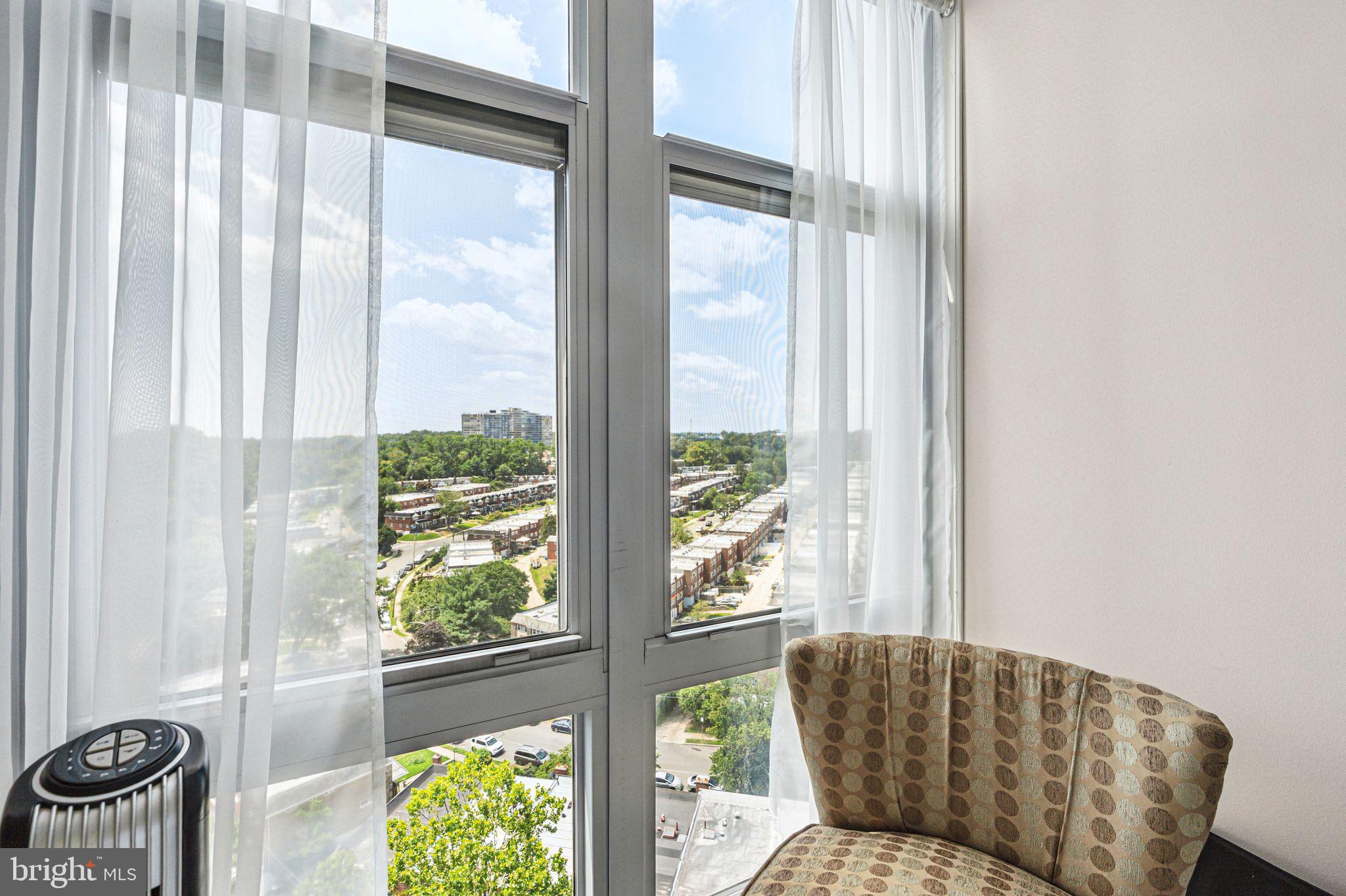 3600 Conshohocken Avenue, Unit 1712 Philadelphia, PA 19131 - Photo 20 of 27 a living room filled with furniture and a potted plant