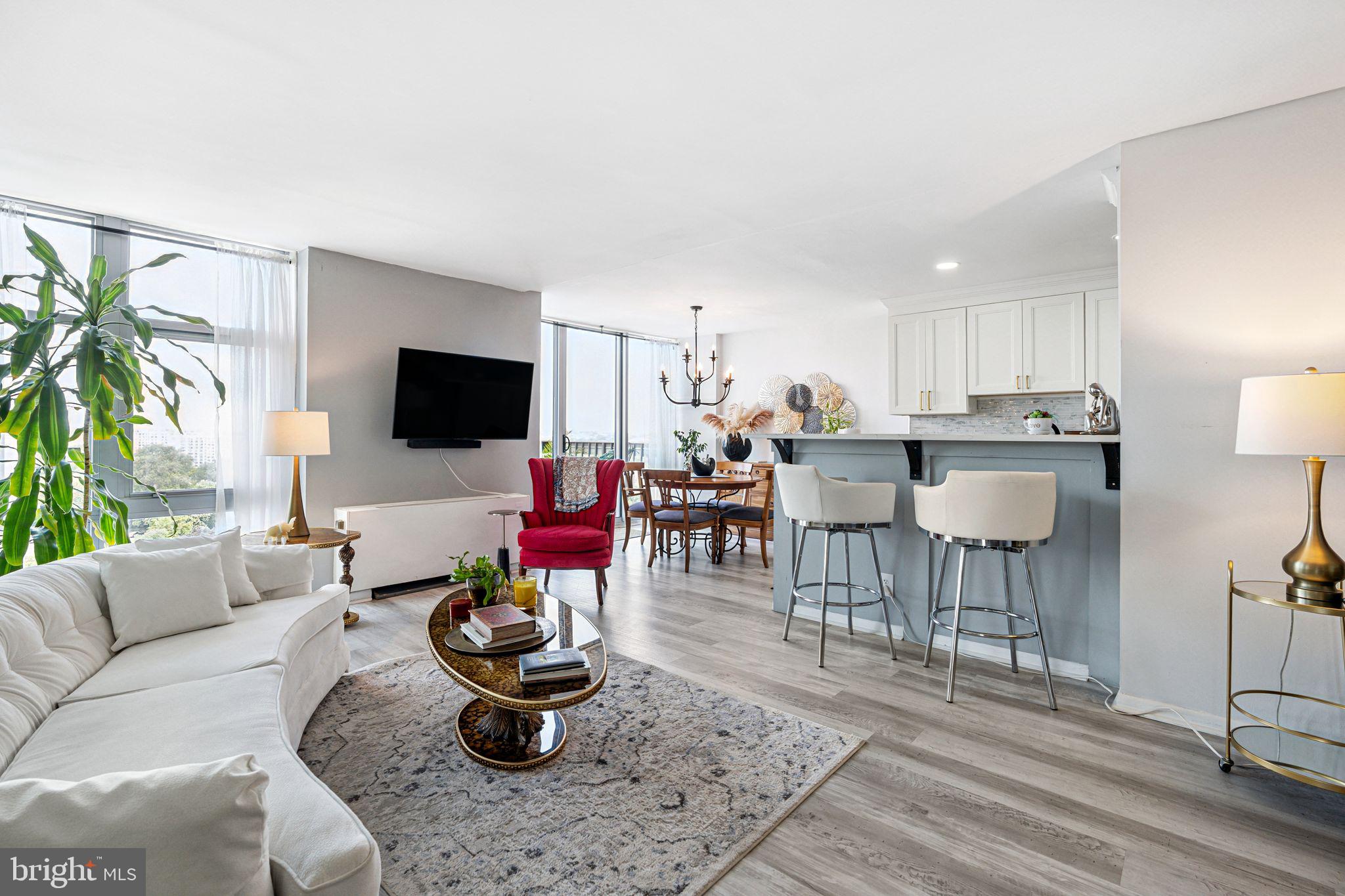 3600 Conshohocken Avenue, Unit 1712 Philadelphia, PA 19131 - Photo 2 of 27 a living room with furniture and a flat screen tv