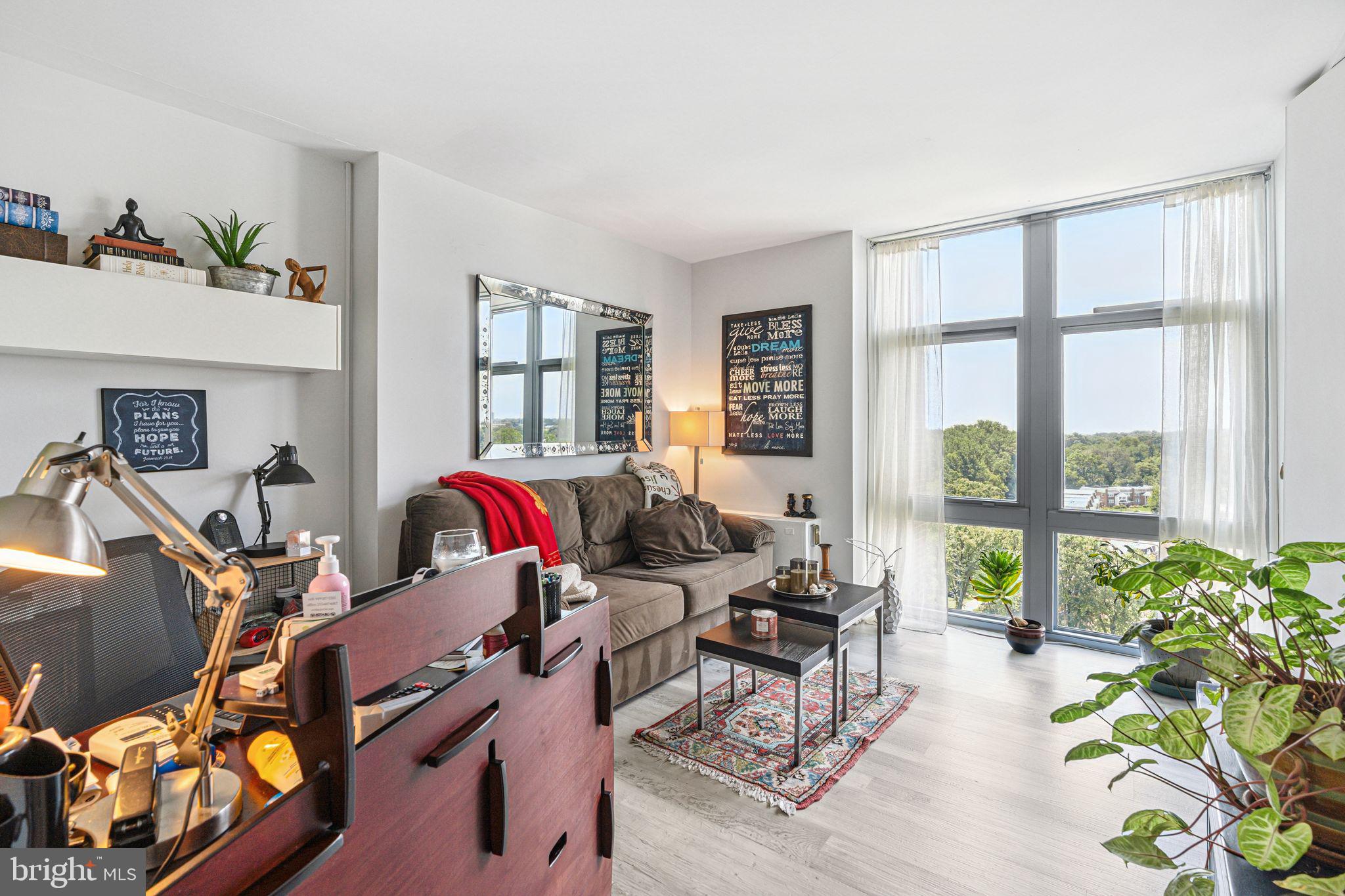 3600 Conshohocken Avenue, Unit 1712 Philadelphia, PA 19131 - Photo 25 of 27 a living room with furniture and floor to ceiling windows