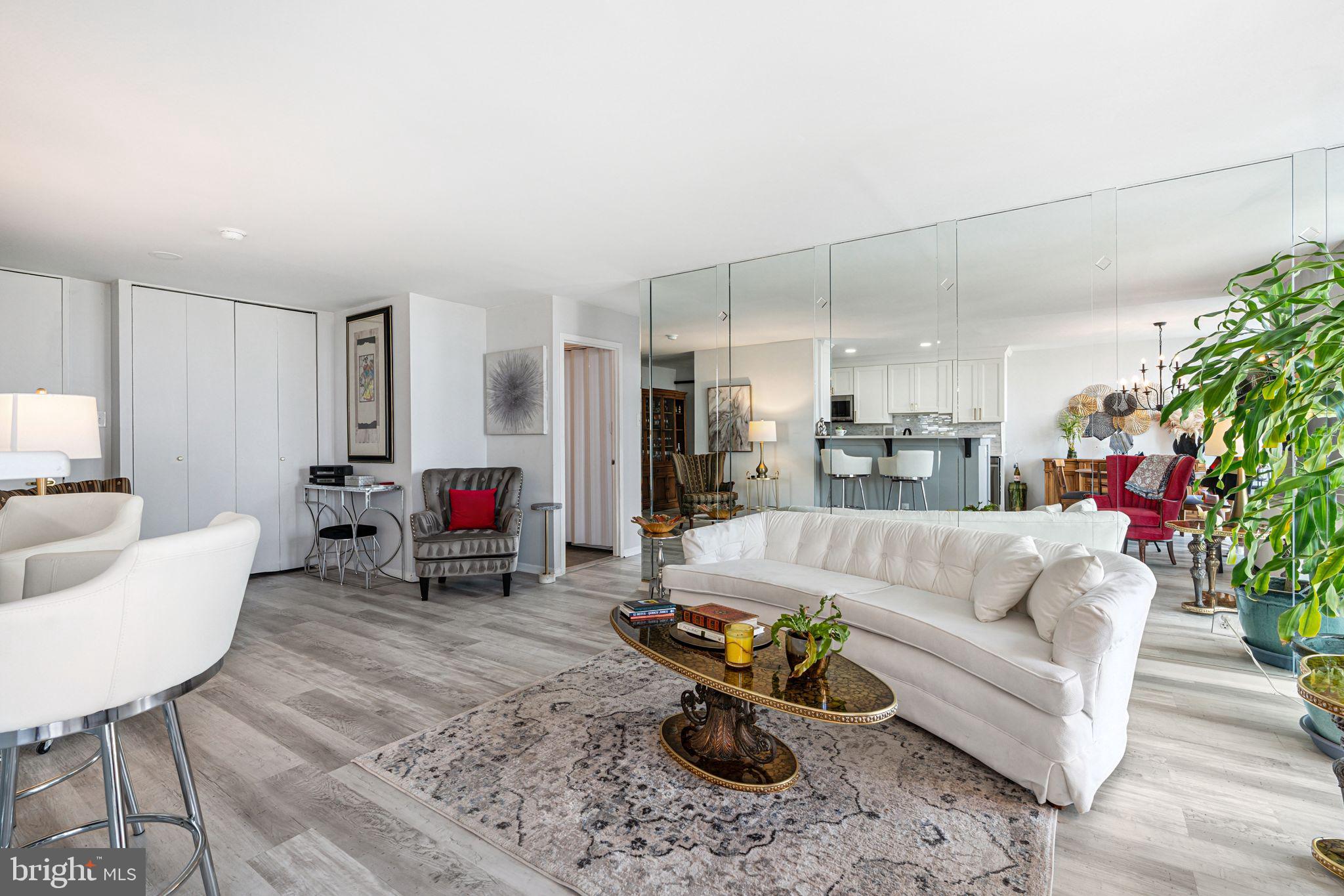 3600 Conshohocken Avenue, Unit 1712 Philadelphia, PA 19131 - Photo 3 of 27 a living room with furniture and a chandelier