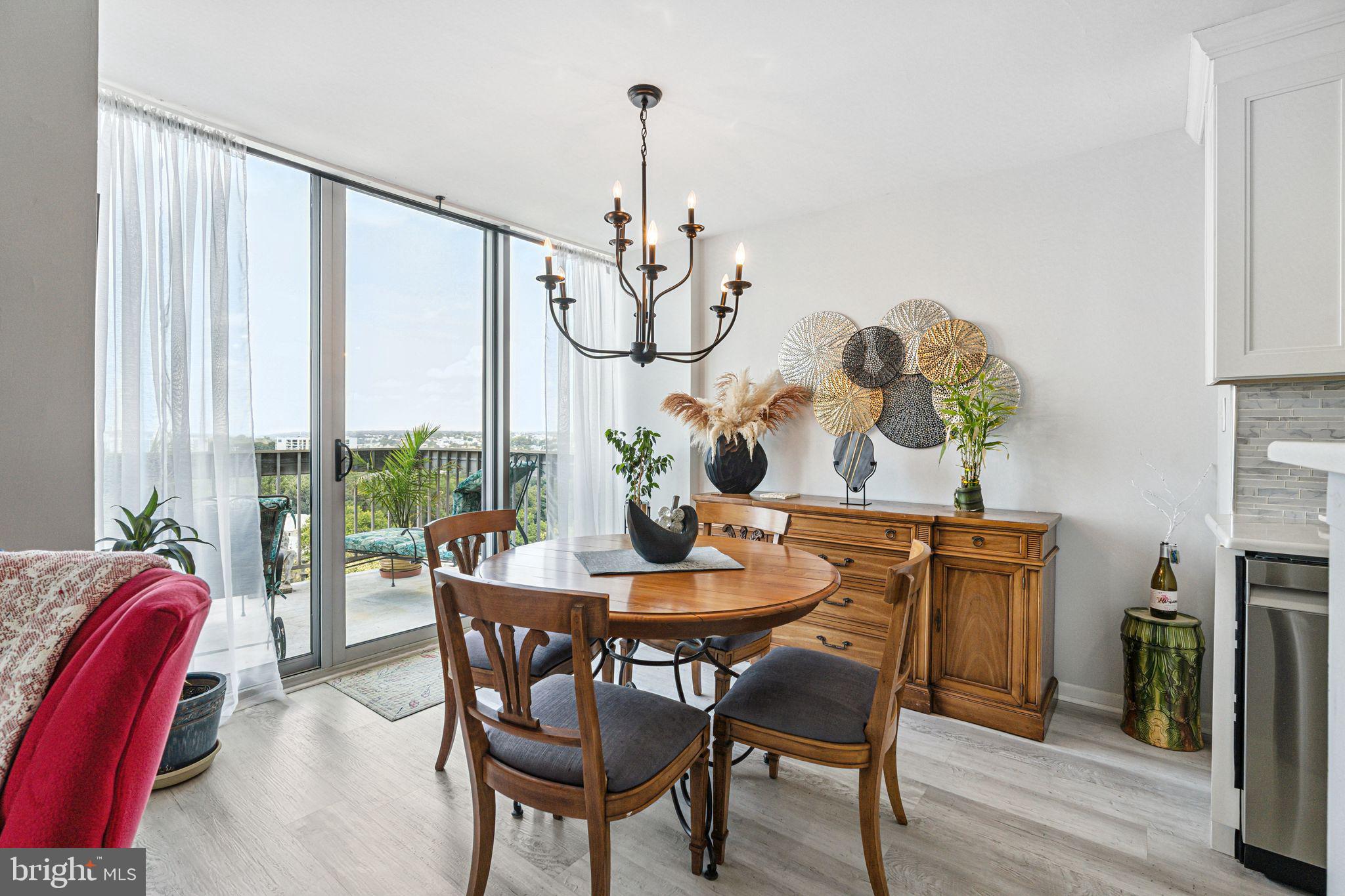3600 Conshohocken Avenue, Unit 1712 Philadelphia, PA 19131 - Photo 4 of 27 a dining room with furniture a chandelier and wooden floor