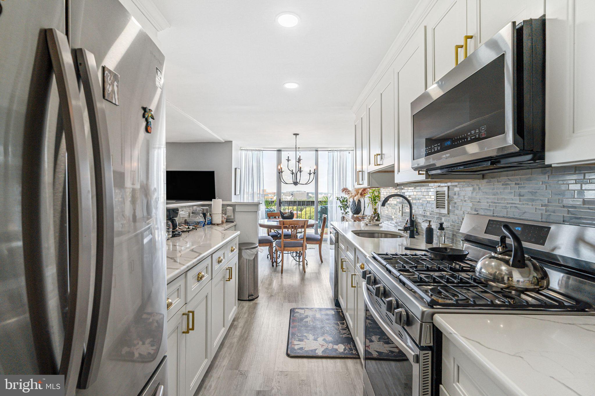 3600 Conshohocken Avenue, Unit 1712 Philadelphia, PA 19131 - Photo 10 of 27 a kitchen with stainless steel appliances a stove a sink and a microwave