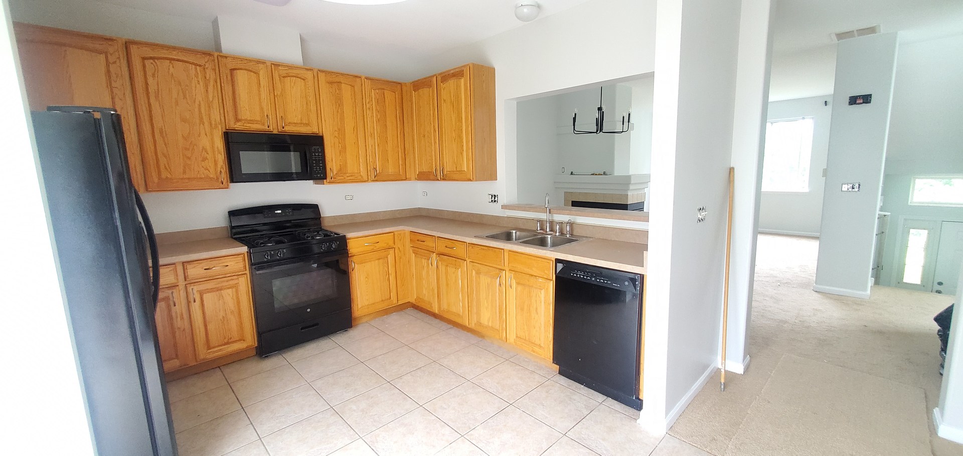 587 South Parkside Drive, Unit 587 Round Lake, IL 60073 - Photo 2 of 9 a kitchen with stainless steel appliances granite countertop a refrigerator stove and sink