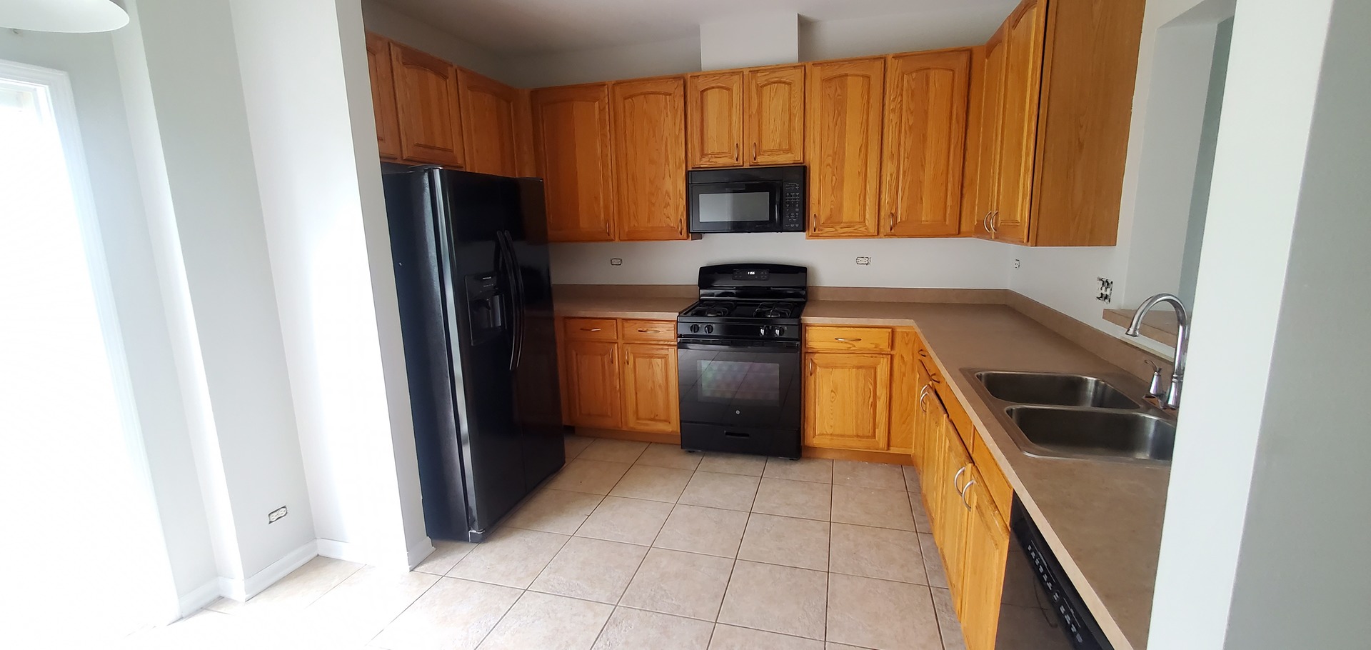 587 South Parkside Drive, Unit 587 Round Lake, IL 60073 - Photo 3 of 9 a kitchen with a refrigerator and a stove