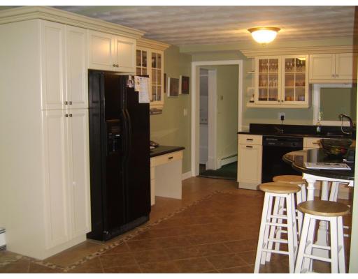 19 Catherine Road Framingham, MA 01701 - Photo 7 of 10 a kitchen with stainless steel appliances granite countertop a refrigerator and a stove