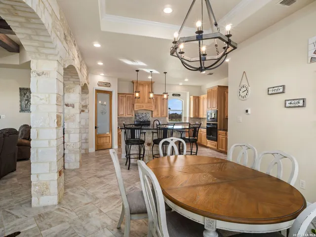 an open kitchen with dining table and stainless steel appliances