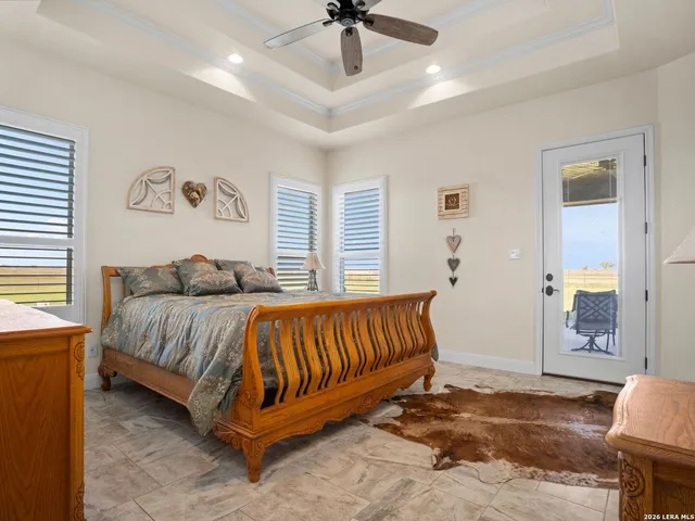 a spacious bedroom with a bed and a chandelier