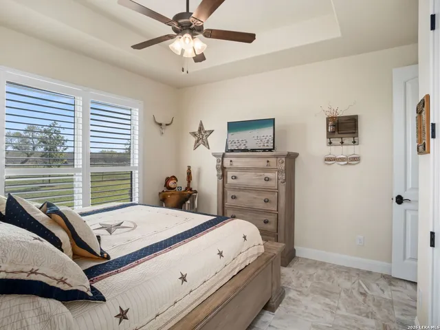 a bathroom with a granite countertop sink and washing machine