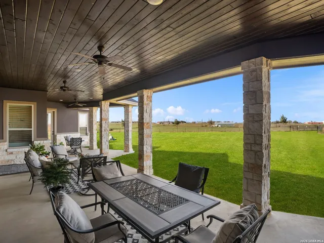 a view of an outdoor dining space with furniture and garden