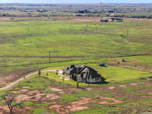 a front view of house with yard and swimming pool