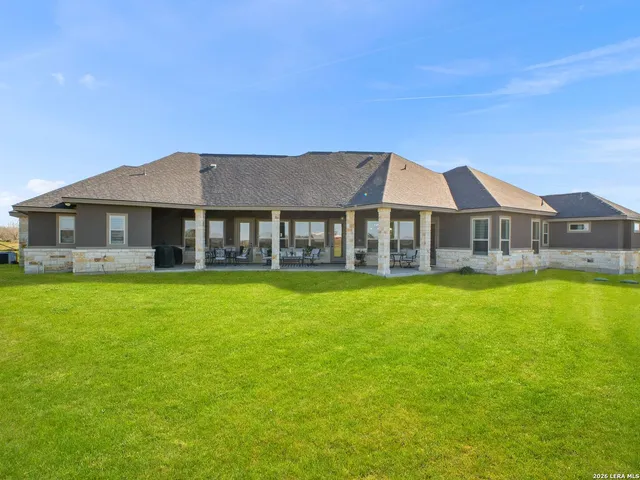 a picture of a room with a white wall and a large window
