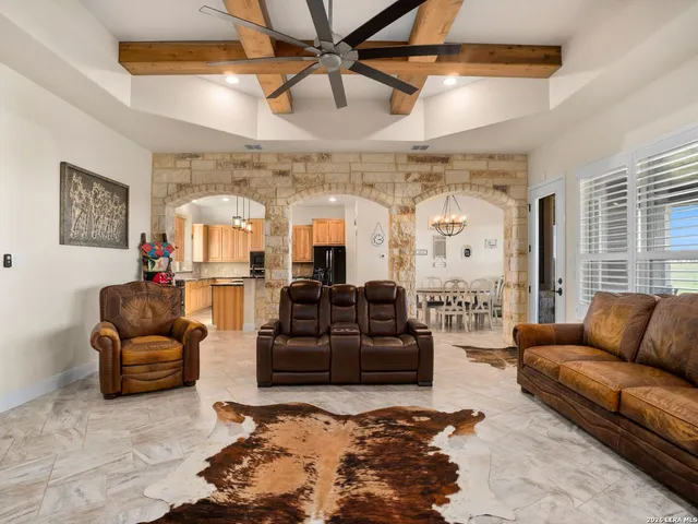 a living room with furniture ceiling fan and a rug