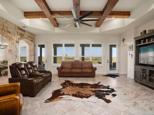 a living room with furniture wooden floor and a flat screen tv