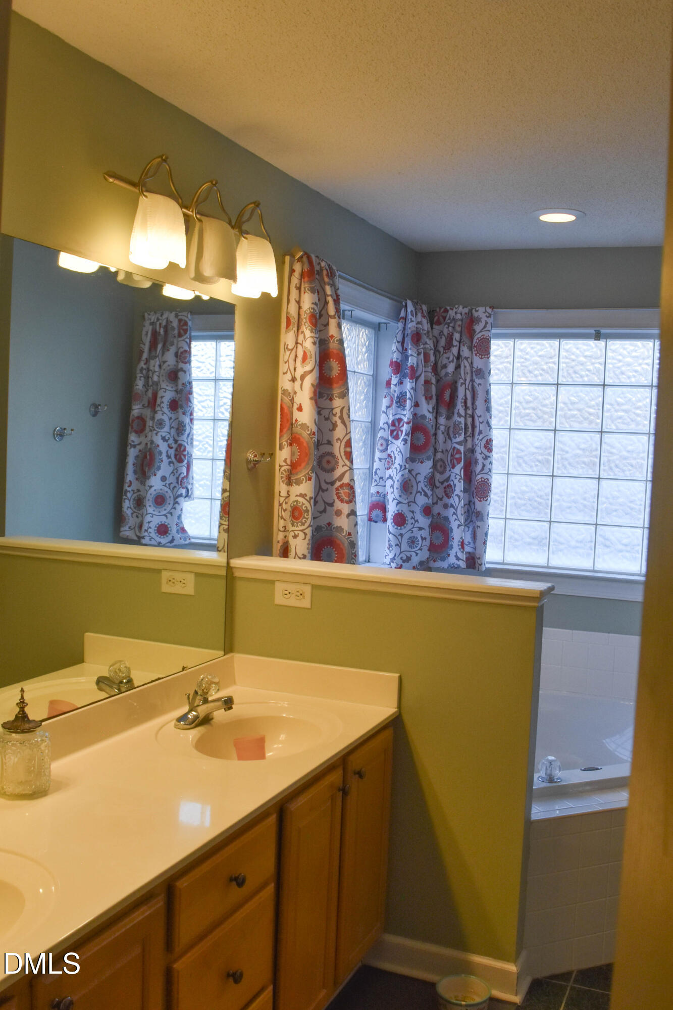 5908 Deep Spring Circle Wake Forest, NC 27587 - Photo 21 of 51 a bathroom with a sink mirror and a bathtub