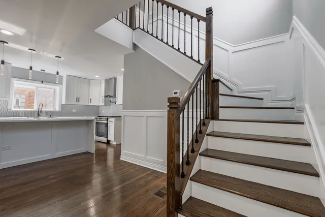a view of kitchen with sink and wooden floor