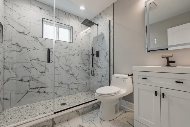 a bathroom with a sink toilet and shower