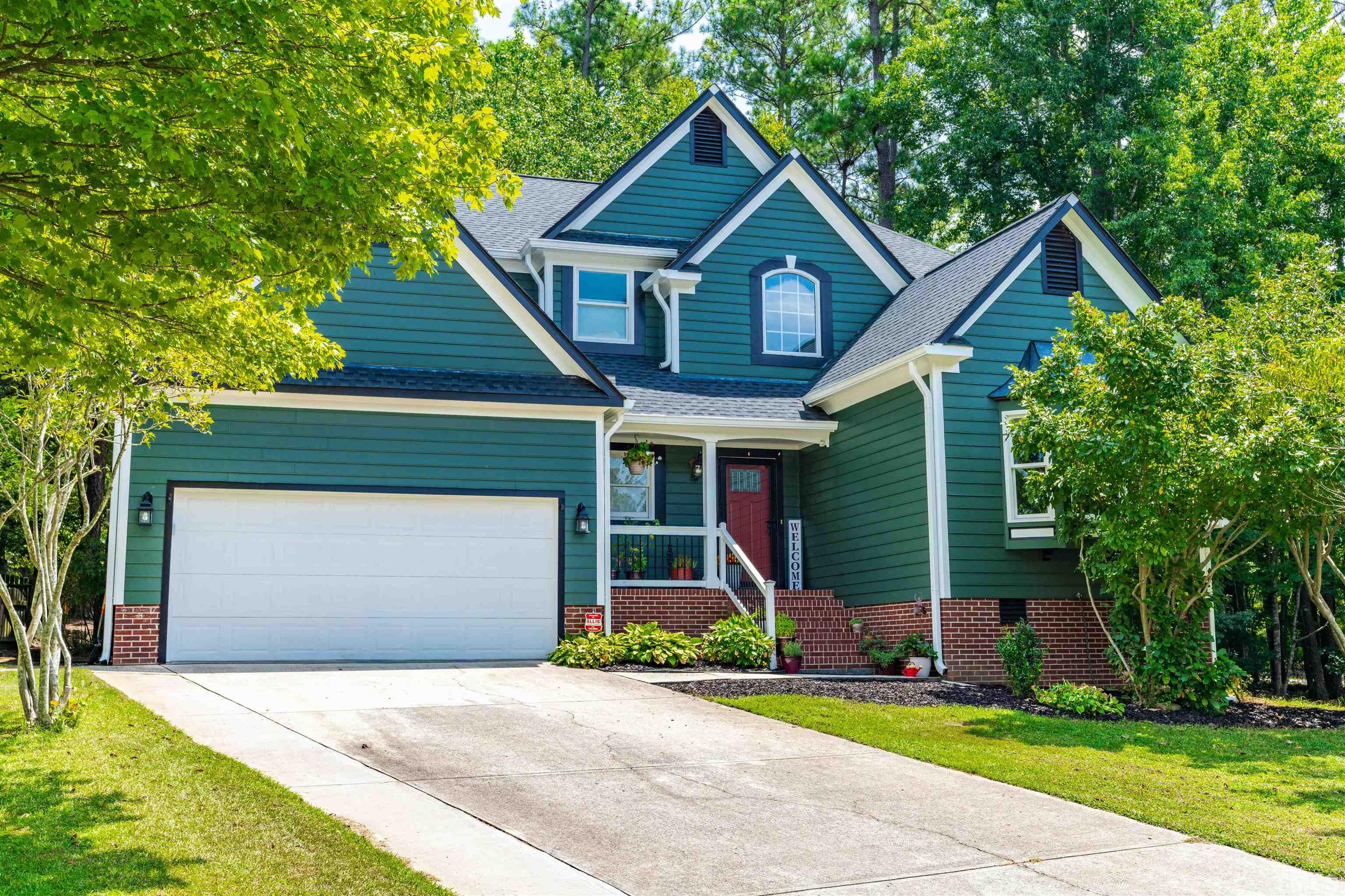 305 Windance Court Cary, NC 27518 - Photo 1 of 38 a front view of a house with a yard and garage