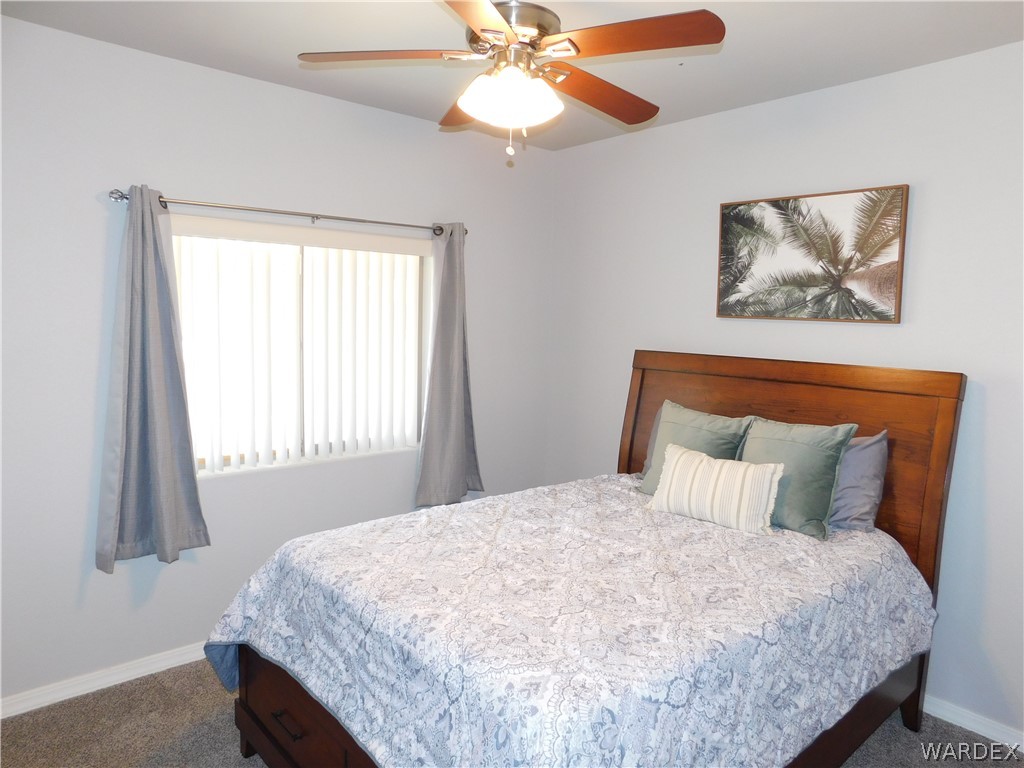 3370 South Ridge Avenue Bullhead City, AZ 86429 - Photo 46 of 56 a bedroom with a bed and a chandelier