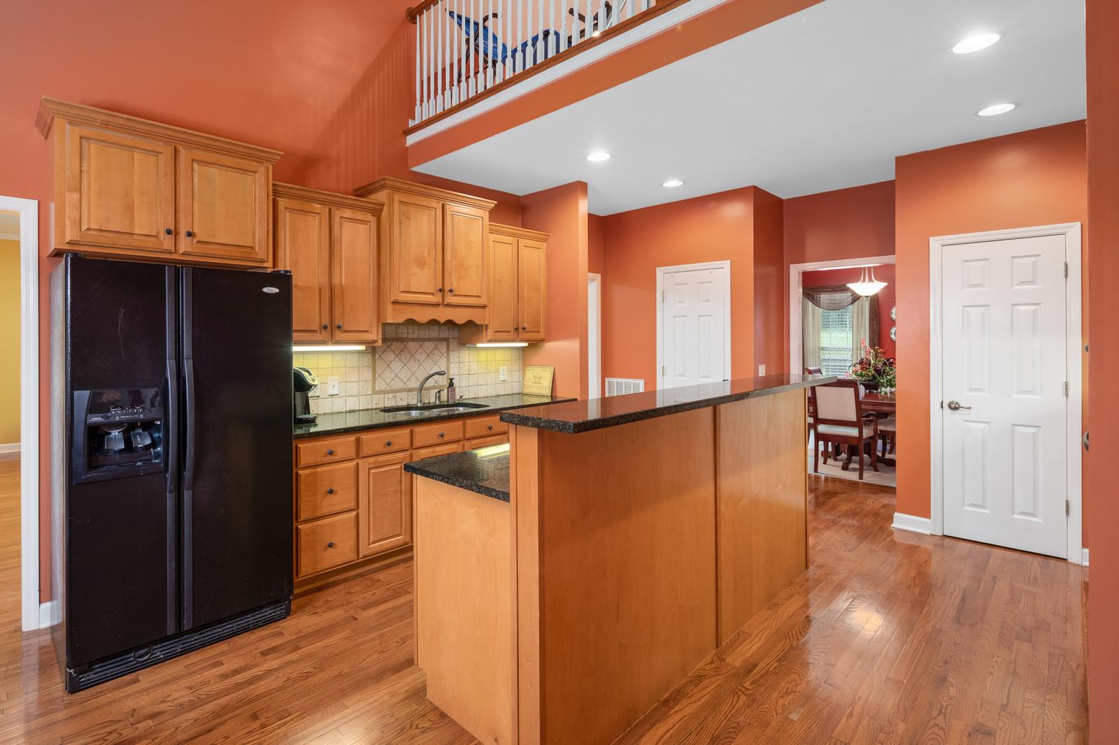 628 Rocky Valley Road Lebanon, TN 37090 - Photo 11 of 30 a kitchen with stainless steel appliances granite countertop a refrigerator cabinets and wooden floor