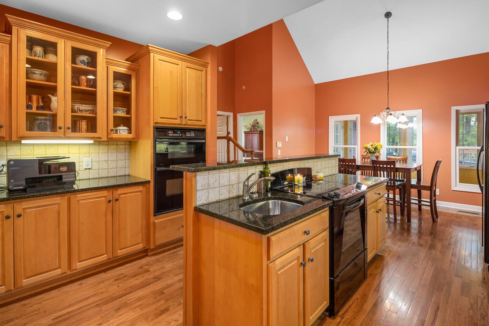 628 Rocky Valley Road Lebanon, TN 37090 - Photo 13 of 30 a kitchen with stainless steel appliances granite countertop a stove a sink dishwasher and a microwave with wooden floor