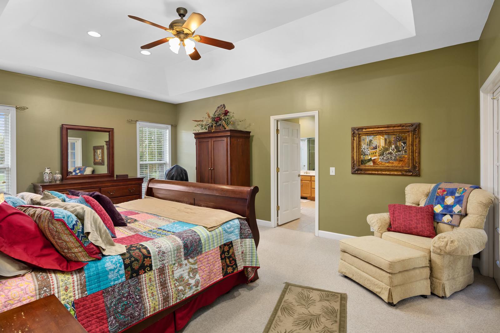 628 Rocky Valley Road Lebanon, TN 37090 - Photo 14 of 30 a bedroom with a bed couch and a chandelier