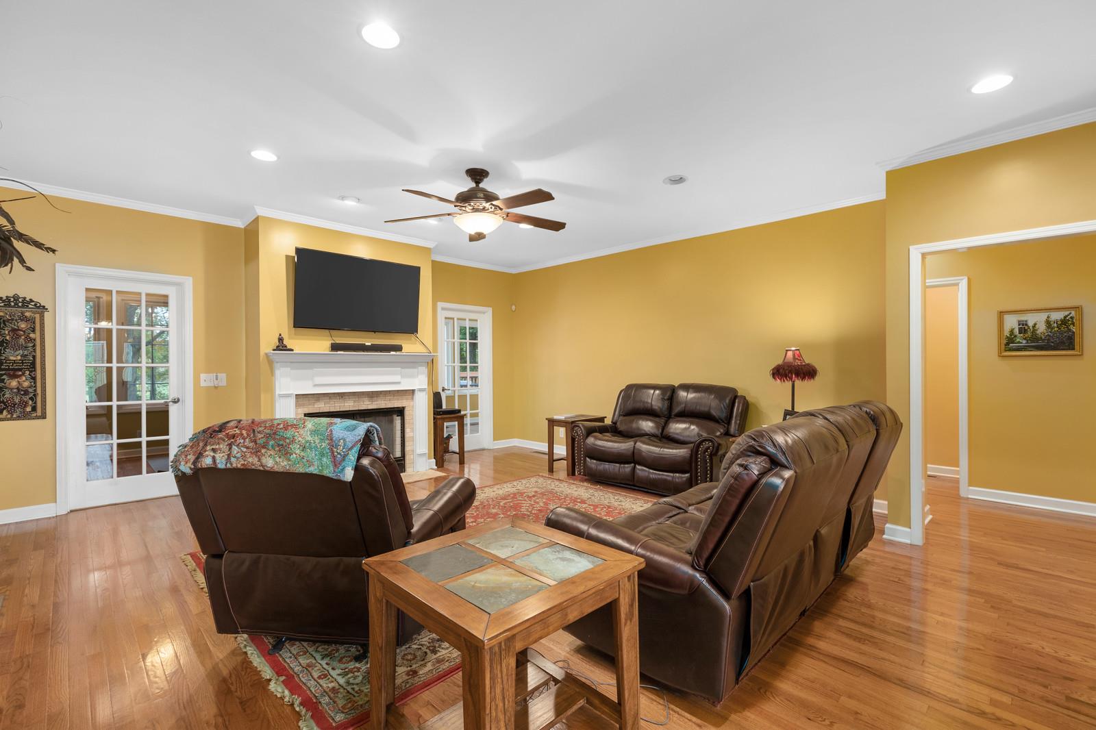 628 Rocky Valley Road Lebanon, TN 37090 - Photo 7 of 30 a living room with furniture a flat screen tv and wooden floor