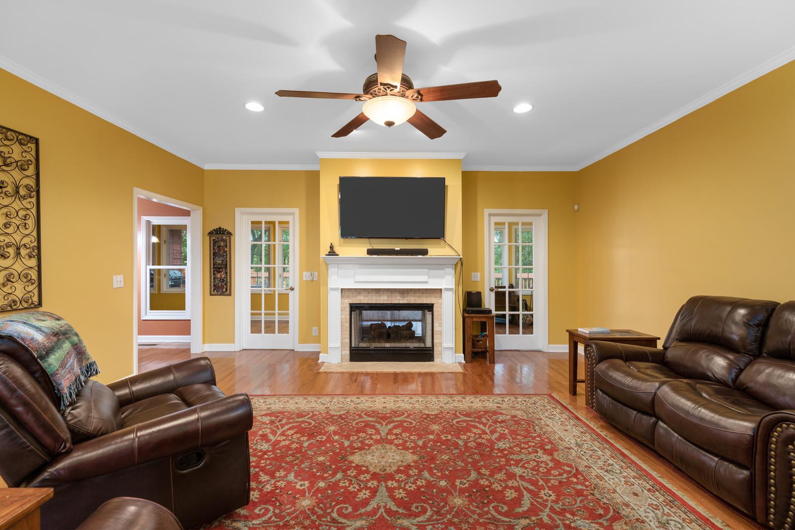 628 Rocky Valley Road Lebanon, TN 37090 - Photo 8 of 30 a living room with furniture a fireplace and a flat screen tv
