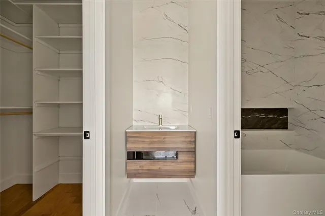 a view of walk in closet with empty racks