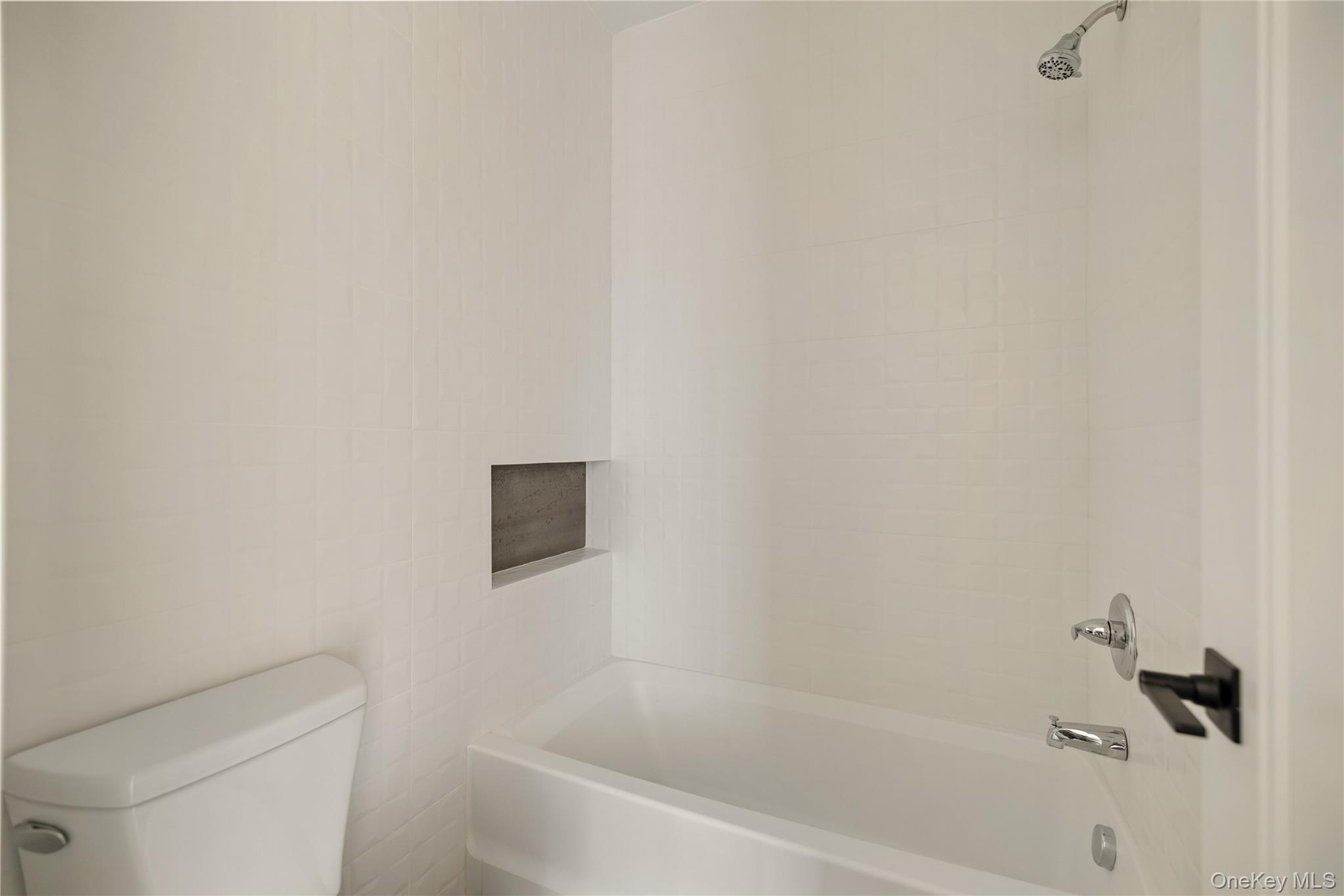 5 Valley Way, Unit 321 Spring Valley, NY 10977 - Photo 36 of 41 a white bath tub sitting next to a white toilet