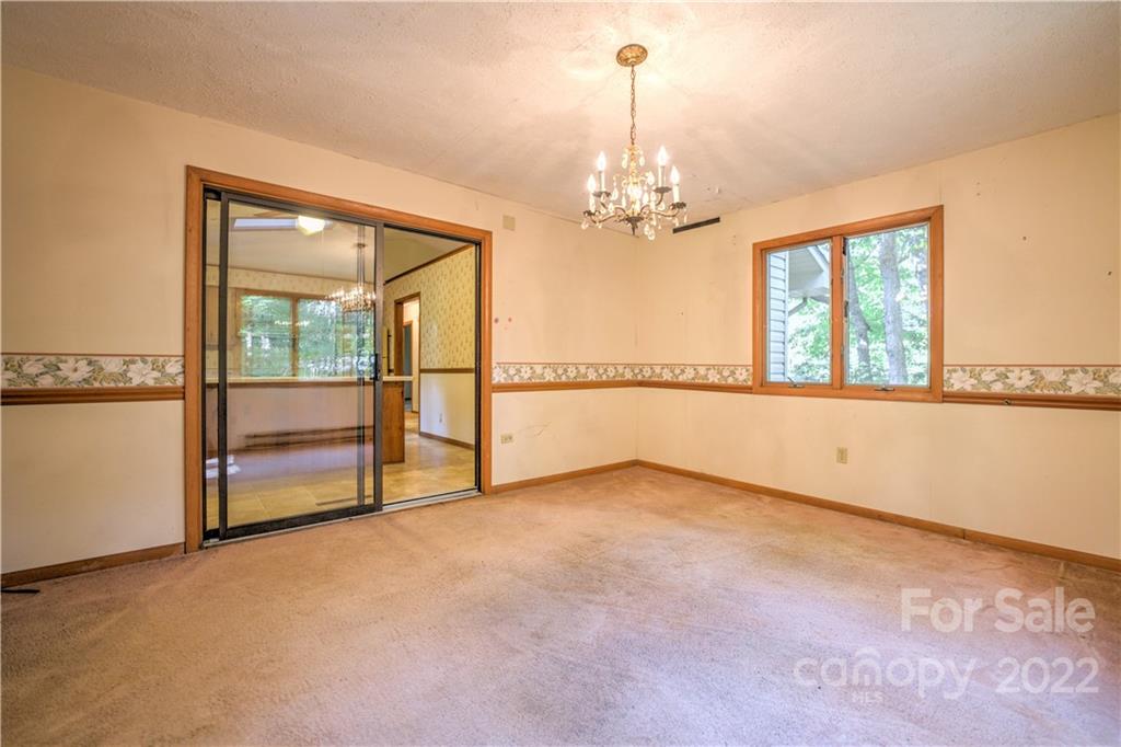 177 Weston Road Arden, NC 28704 - Photo 14 of 36 wooden floor chandelier and windows in an empty room