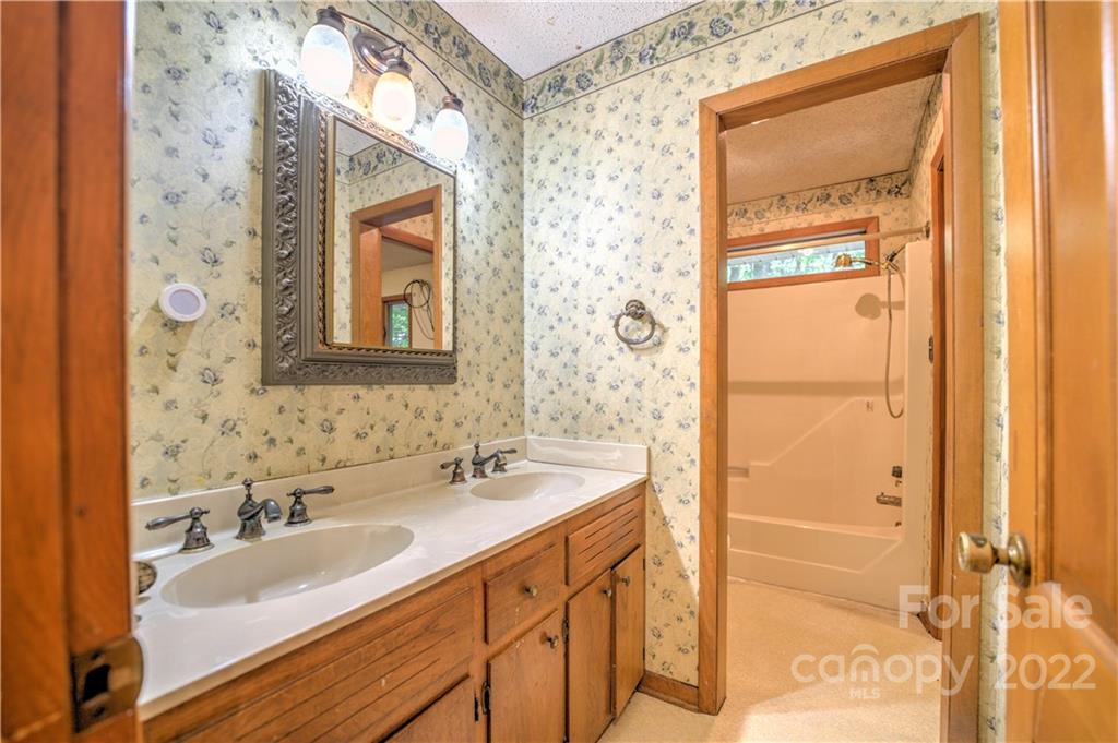 177 Weston Road Arden, NC 28704 - Photo 17 of 36 a bathroom with a sink and a mirror