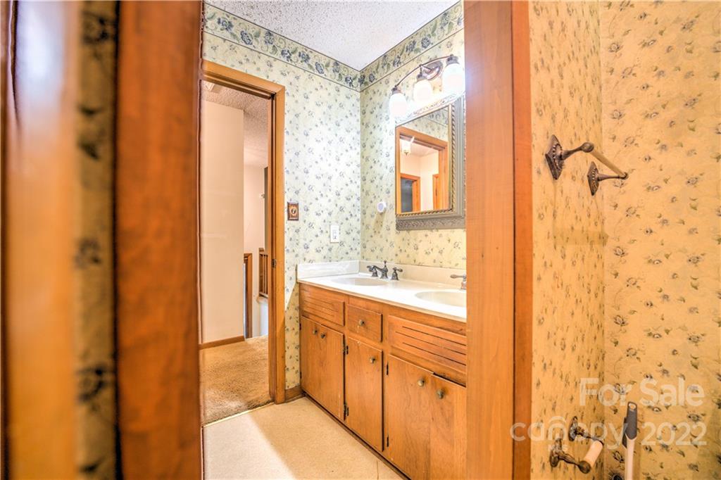 177 Weston Road Arden, NC 28704 - Photo 19 of 36 a bathroom with a sink and a mirror