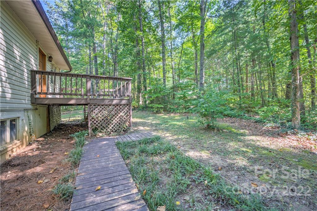 177 Weston Road Arden, NC 28704 - Photo 32 of 36 a view of a pathway of a house with backyard and trees