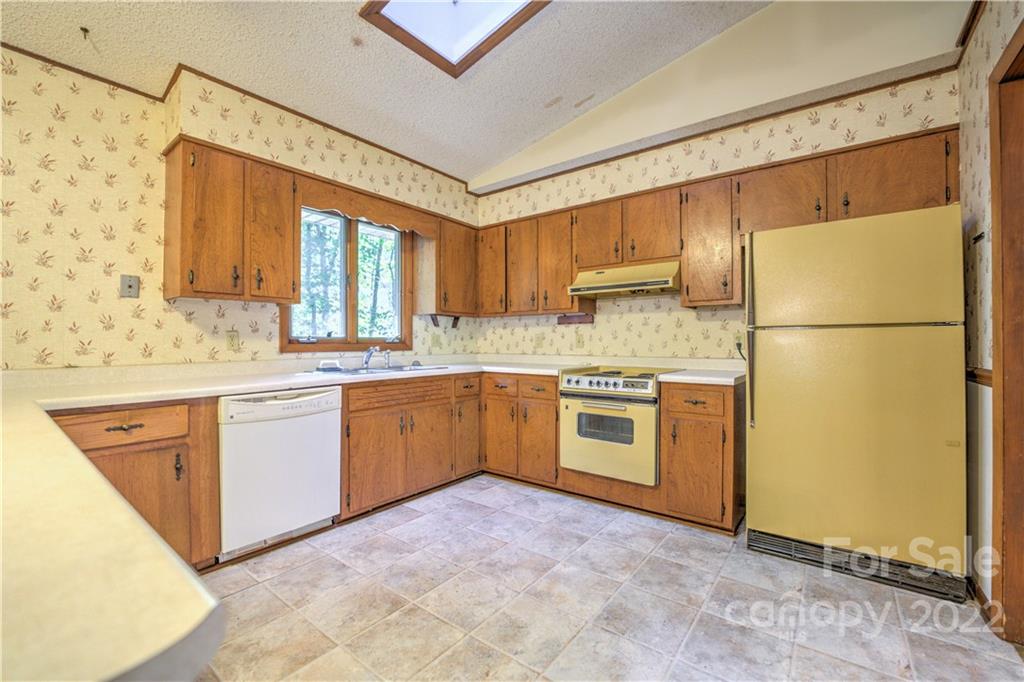 177 Weston Road Arden, NC 28704 - Photo 10 of 36 a kitchen with a sink a stove a refrigerator and cabinets