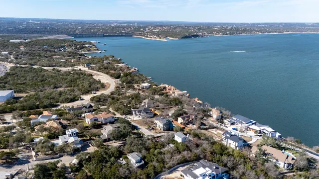 an aerial view of residential houses with city and green space