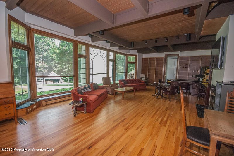 145 Carbondale Road Waverly, PA 18471 - Photo 33 of 98 a living room with furniture a wooden floor and a large window