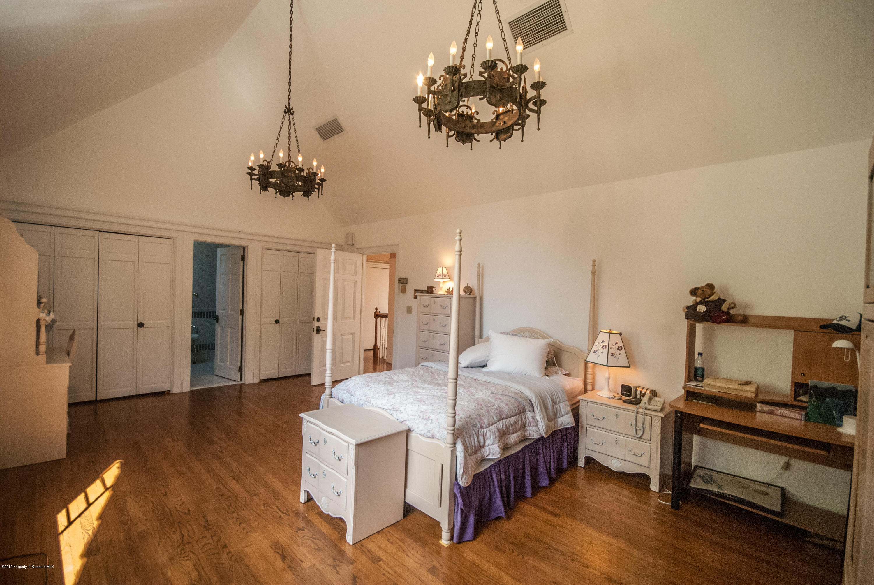 145 Carbondale Road Waverly, PA 18471 - Photo 47 of 98 a spacious bedroom with a bed and a chandelier