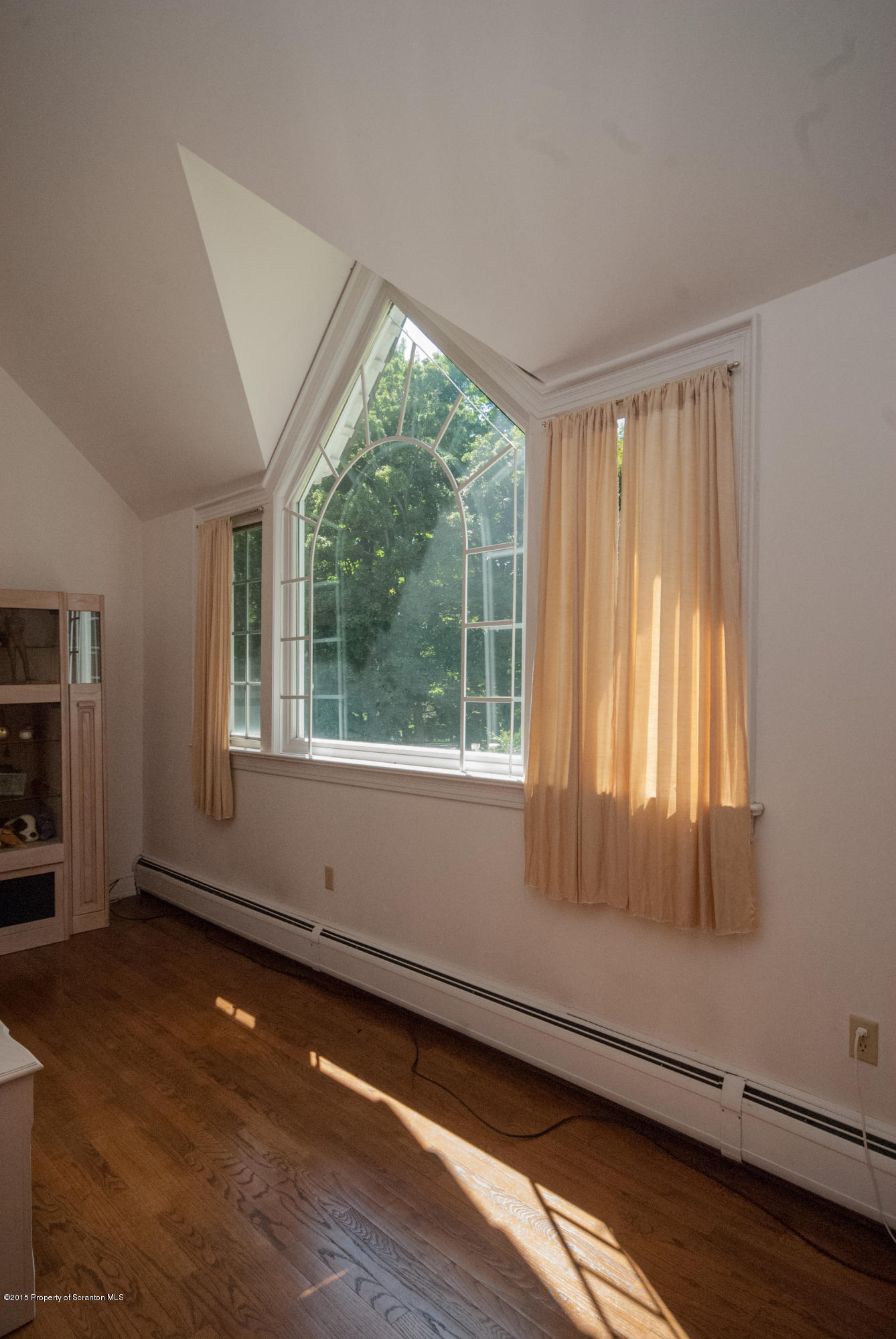145 Carbondale Road Waverly, PA 18471 - Photo 49 of 98 a view of an empty room with wooden floor and a window