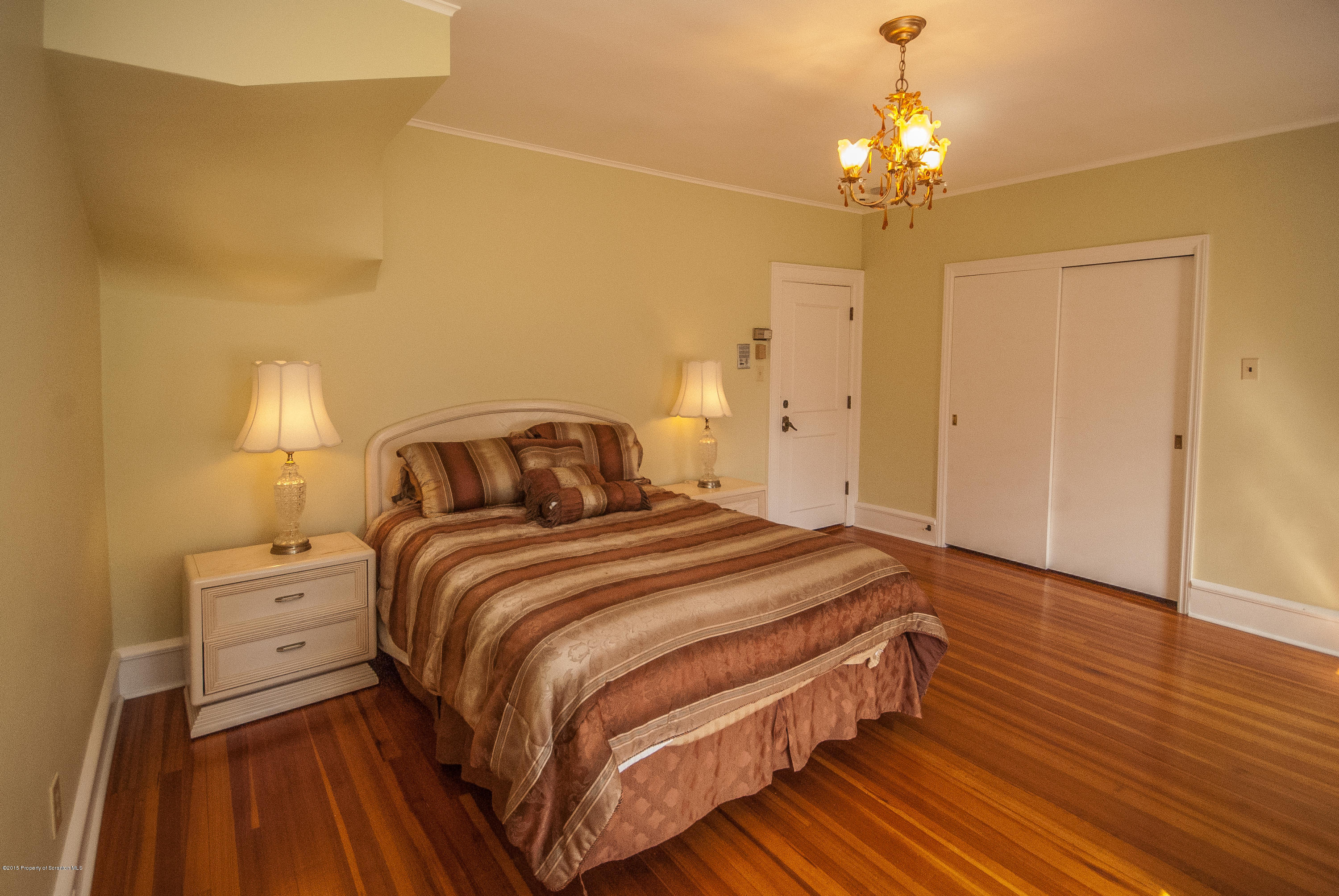 145 Carbondale Road Waverly, PA 18471 - Photo 65 of 98 a bedroom with a bed and wooden floor