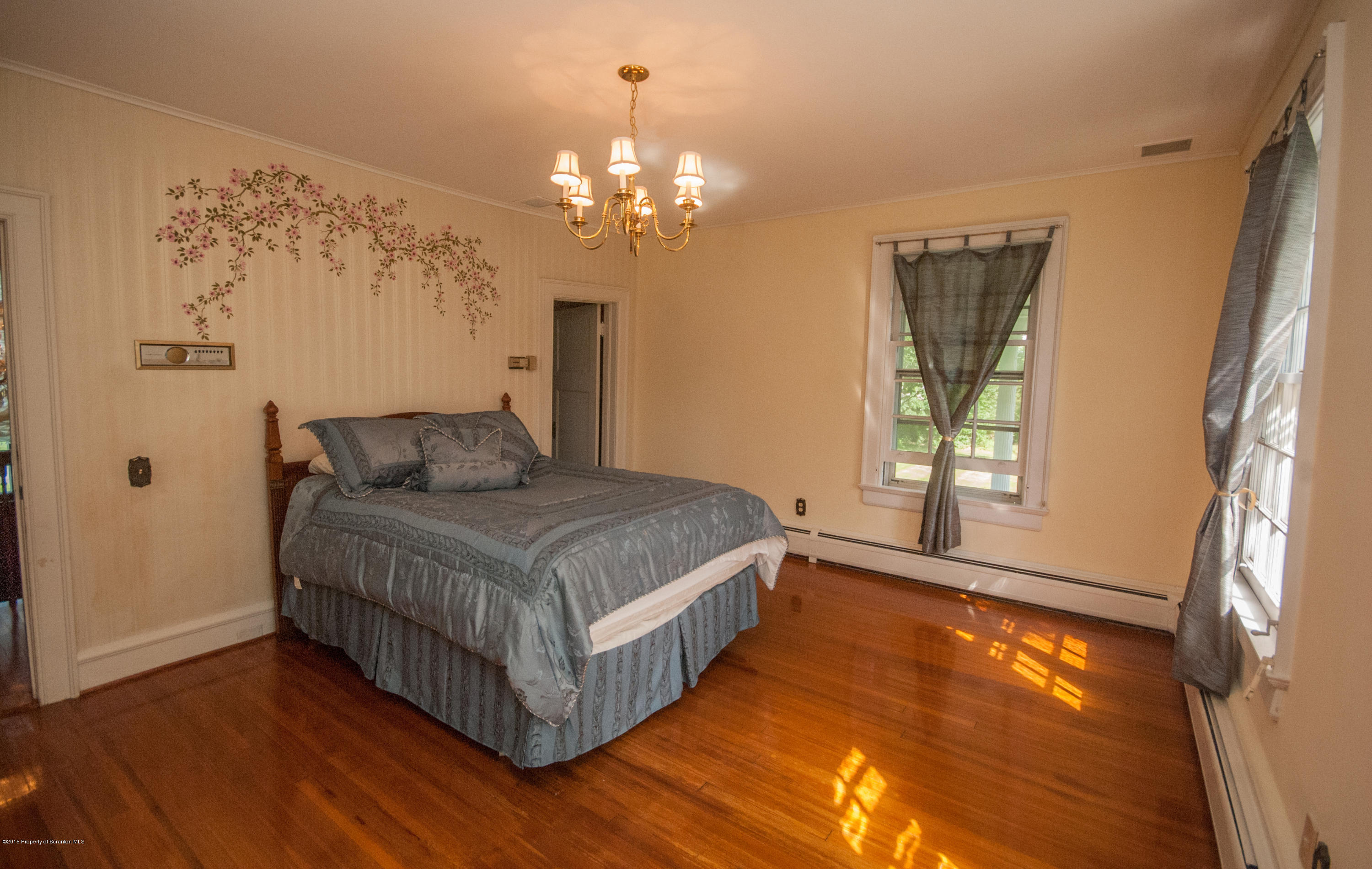 145 Carbondale Road Waverly, PA 18471 - Photo 68 of 98 a bedroom with a bed chandelier and a window