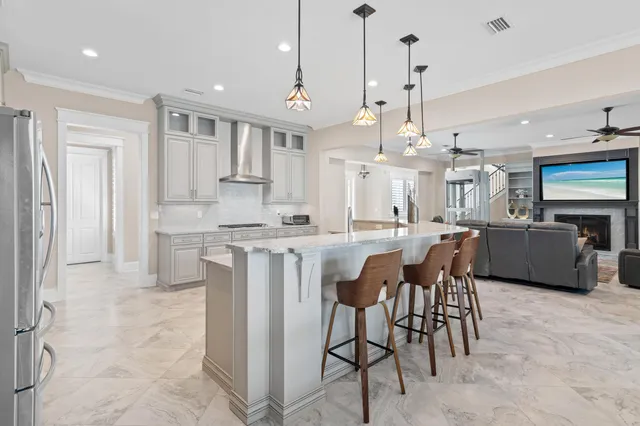 a large kitchen with a table and chairs