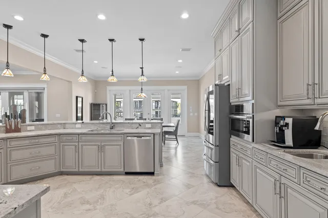 a large kitchen with lots of counter space sink and appliances