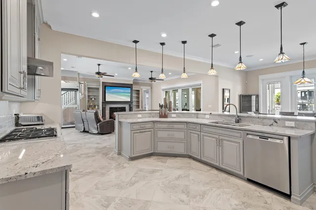 a large kitchen with kitchen island a large counter space a sink stainless steel appliances and cabinets