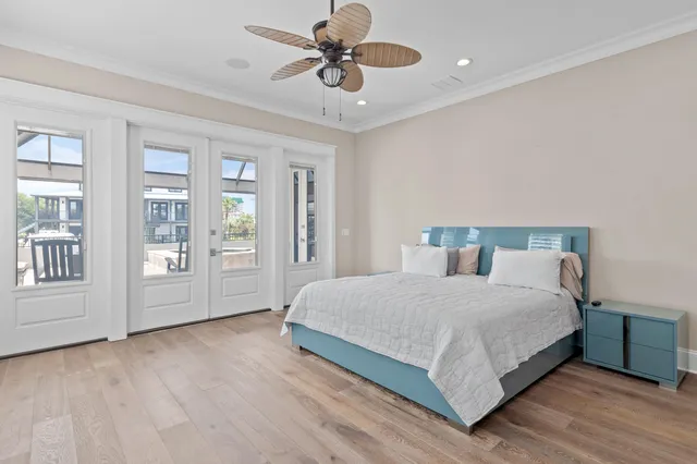 a bedroom with a large bed chandelier and a window
